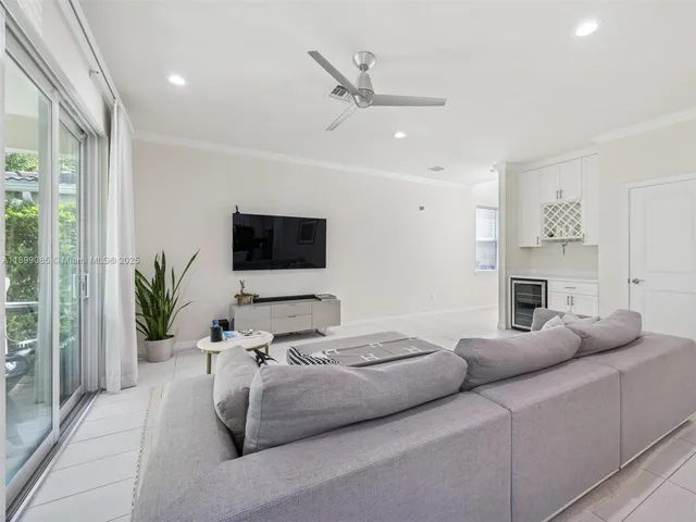 a kitchen with stainless steel appliances kitchen island granite countertop a stove a sink a dining table and chairs