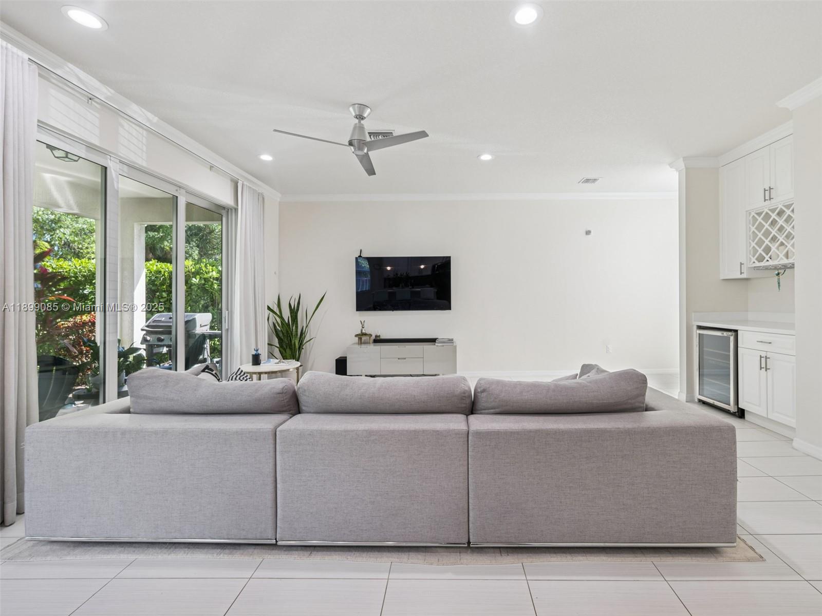 4325 Large Leaf Lane Hollywood, FL 33021 - Photo 13 of 72 a living room with furniture a flat screen tv and a large window