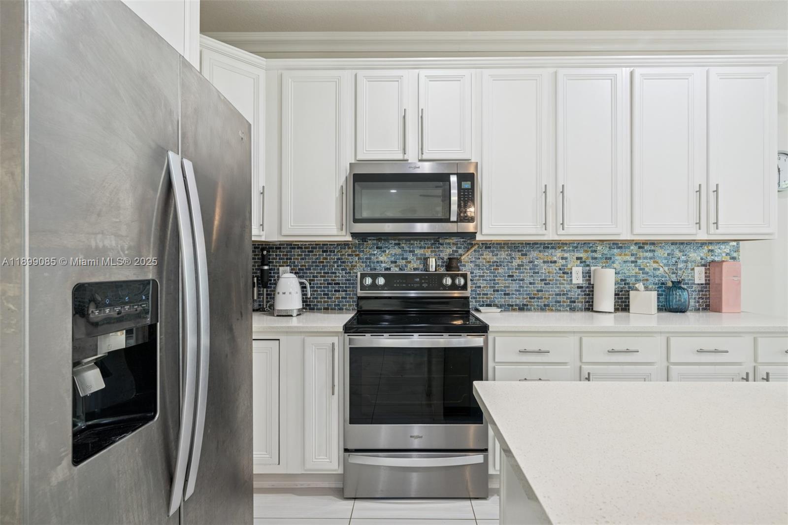 4325 Large Leaf Lane Hollywood, FL 33021 - Photo 16 of 72 a kitchen with granite countertop a refrigerator stove and microwave