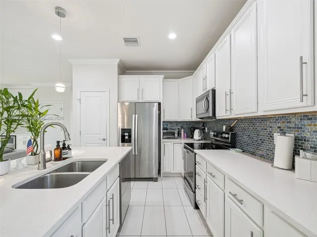 a large bed sitting in a bedroom next to a window