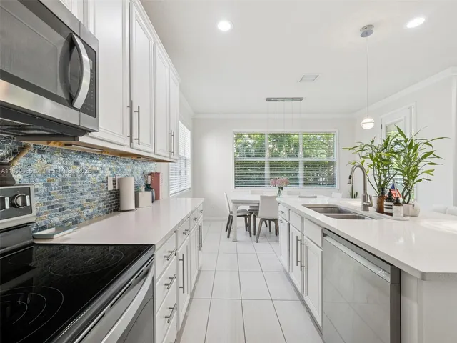 a large bed sitting in a bedroom next to a window