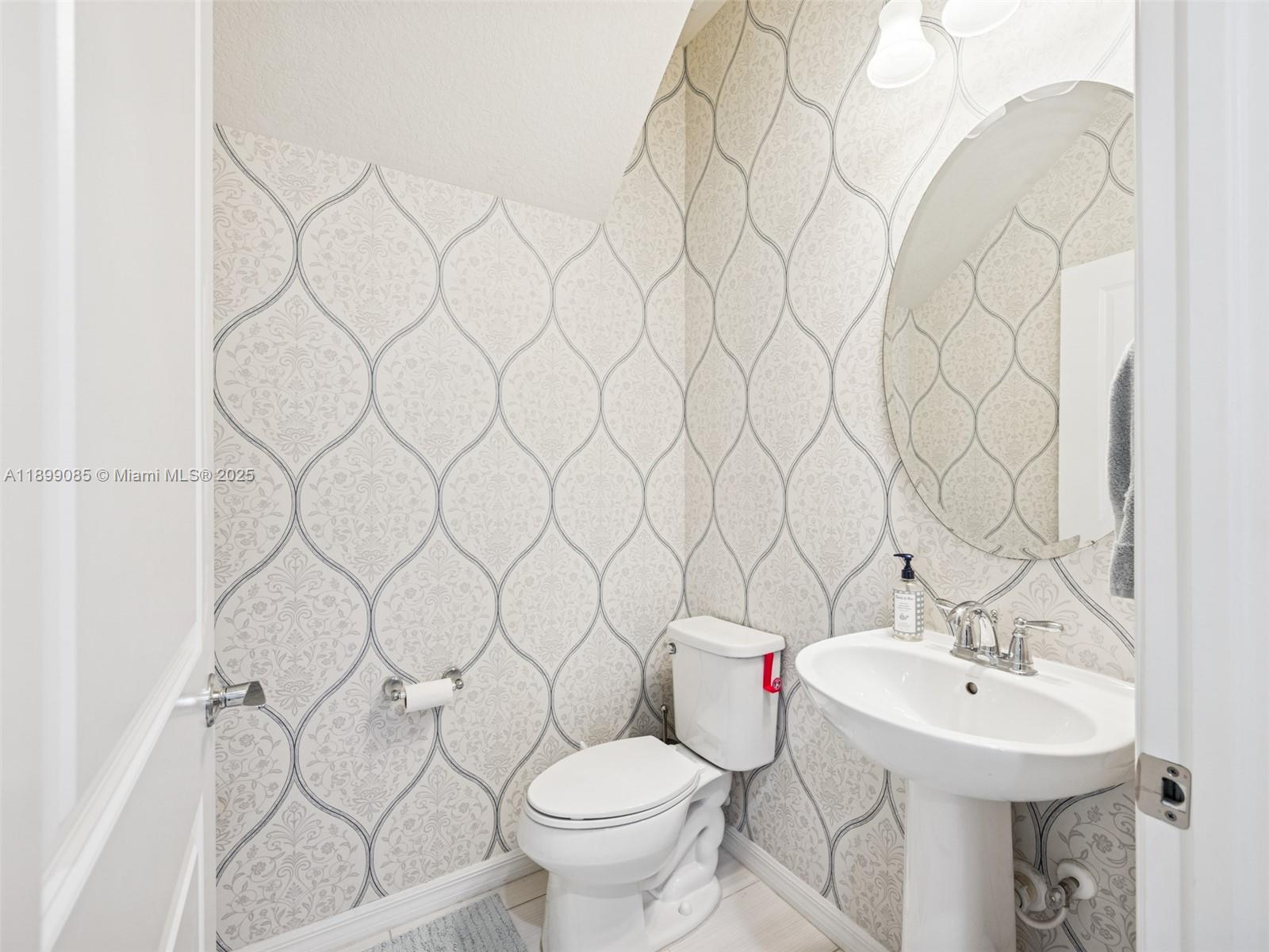 4325 Large Leaf Lane Hollywood, FL 33021 - Photo 25 of 72 a bathroom with a sink toilet and a mirror