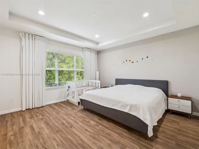 a bedroom with a large bed and a book shelf