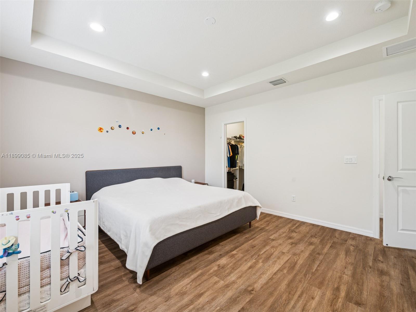 4325 Large Leaf Lane Hollywood, FL 33021 - Photo 33 of 72 a bedroom with a large bed and a book shelf