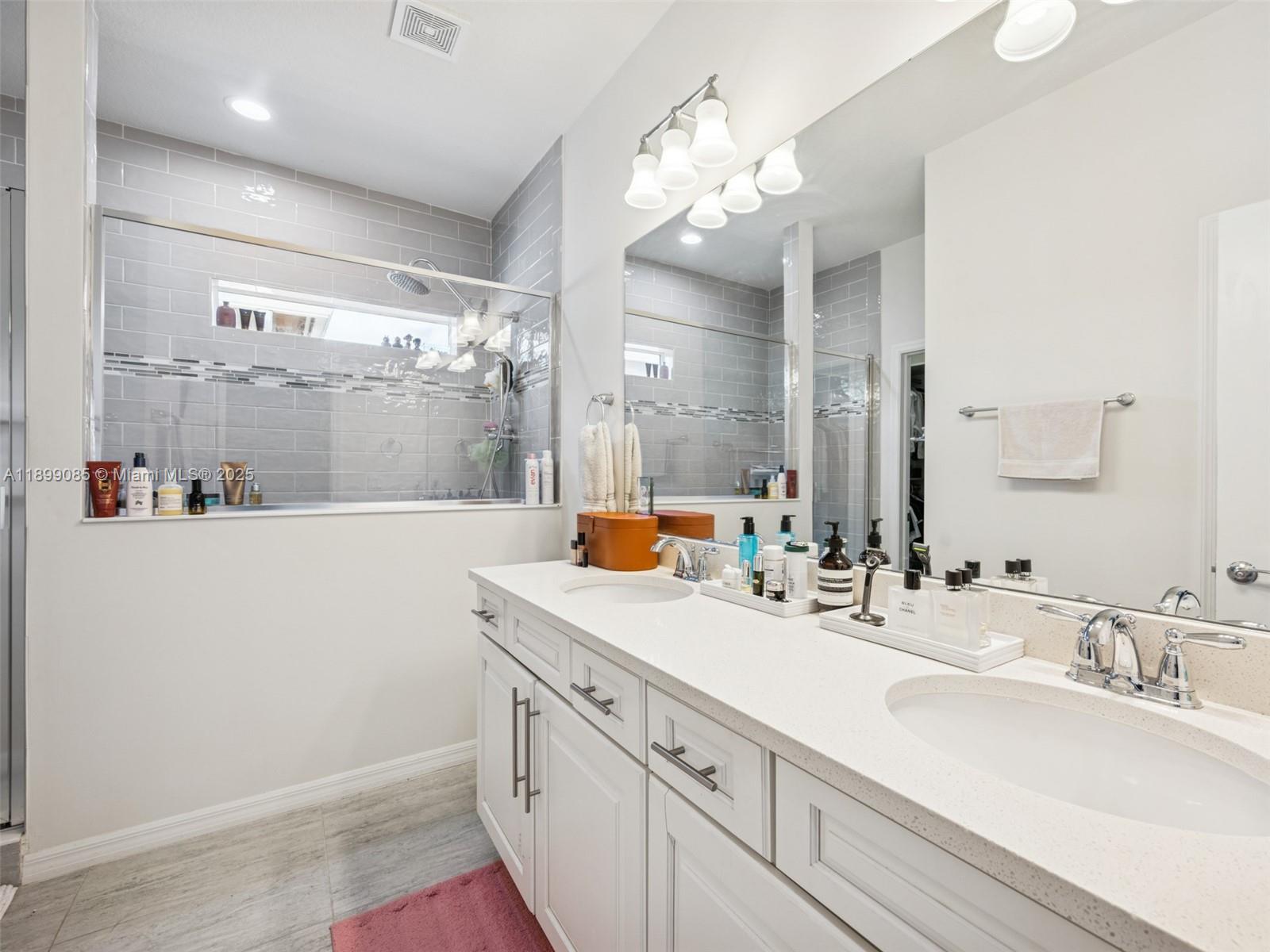 4325 Large Leaf Lane Hollywood, FL 33021 - Photo 36 of 72 a bathroom with a sink double vanity and a mirror