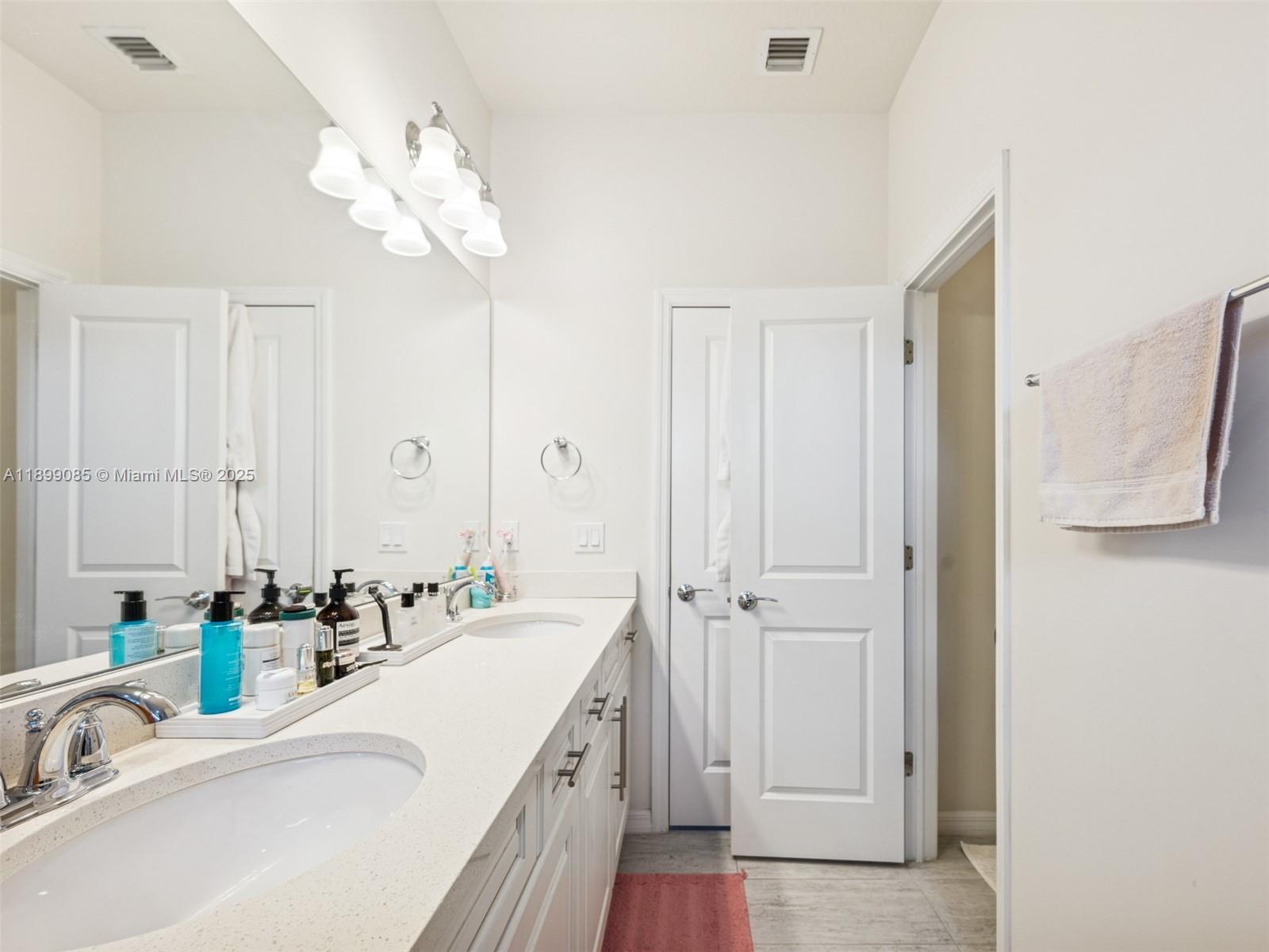 4325 Large Leaf Lane Hollywood, FL 33021 - Photo 37 of 72 a bathroom with a sink vanity and a mirror