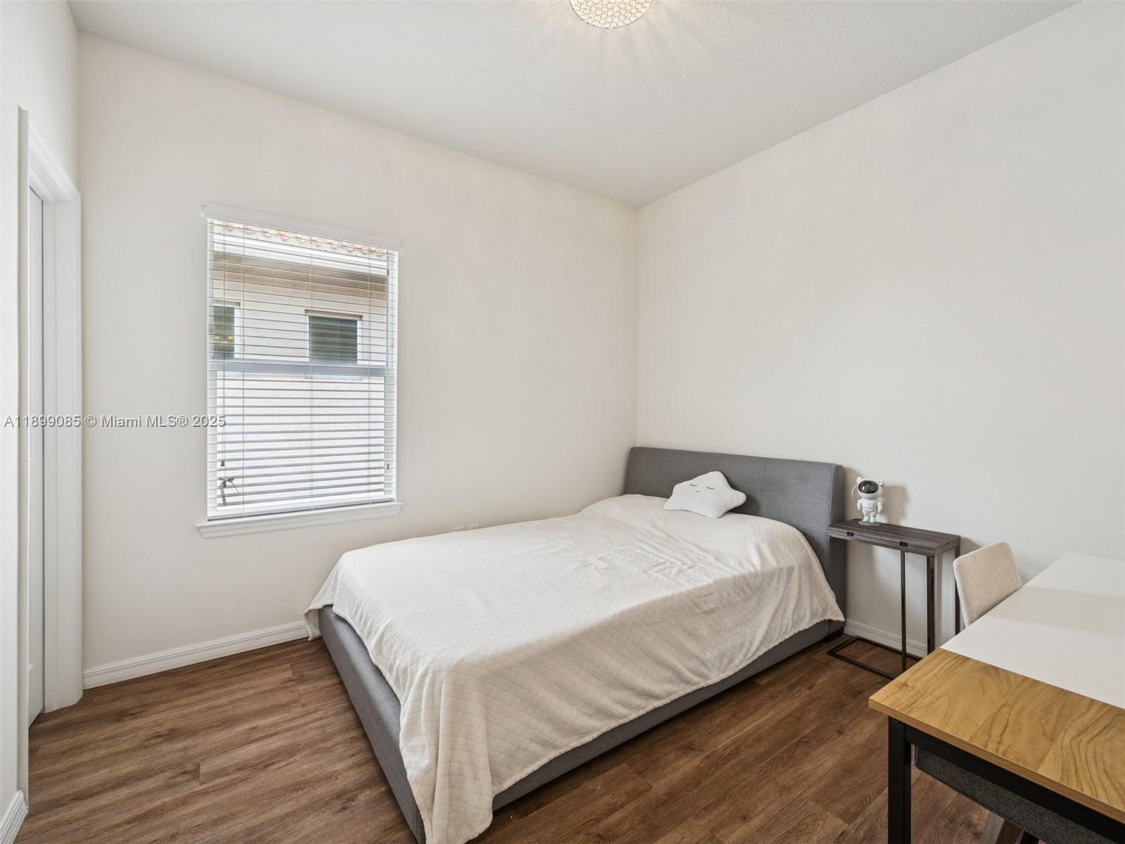 4325 Large Leaf Lane Hollywood, FL 33021 - Photo 41 of 72 a bedroom with a bed and wooden floor