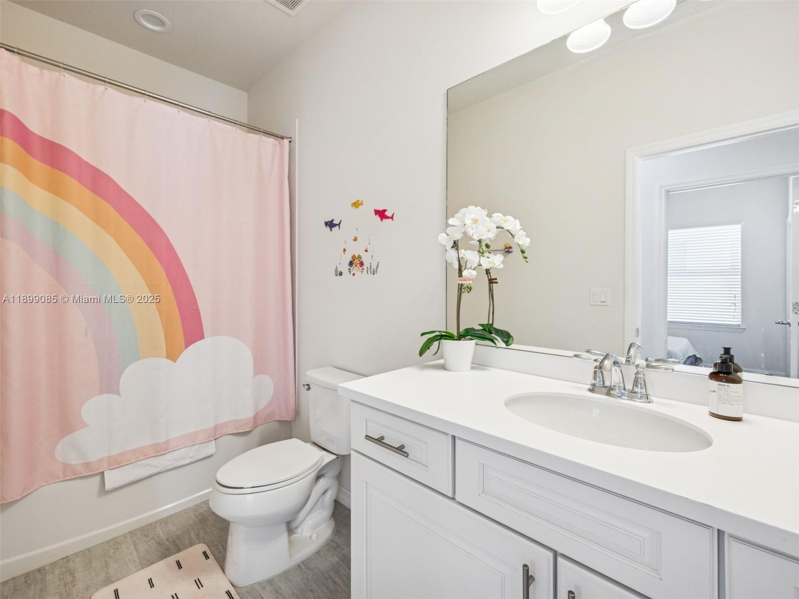 4325 Large Leaf Lane Hollywood, FL 33021 - Photo 43 of 72 a bathroom with a sink a toilet and a mirror