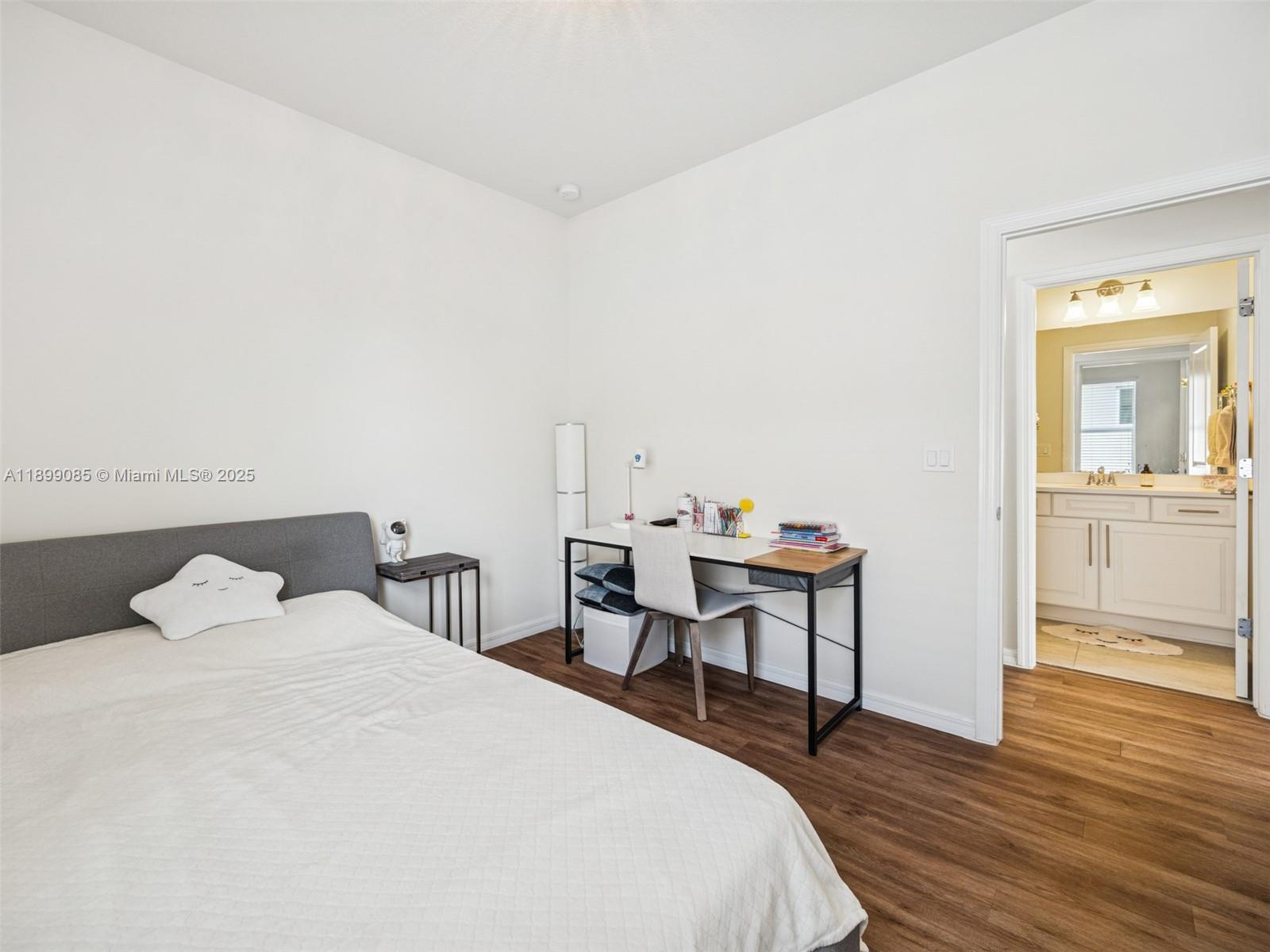 4325 Large Leaf Lane Hollywood, FL 33021 - Photo 44 of 72 a bedroom with a bed and wooden floor