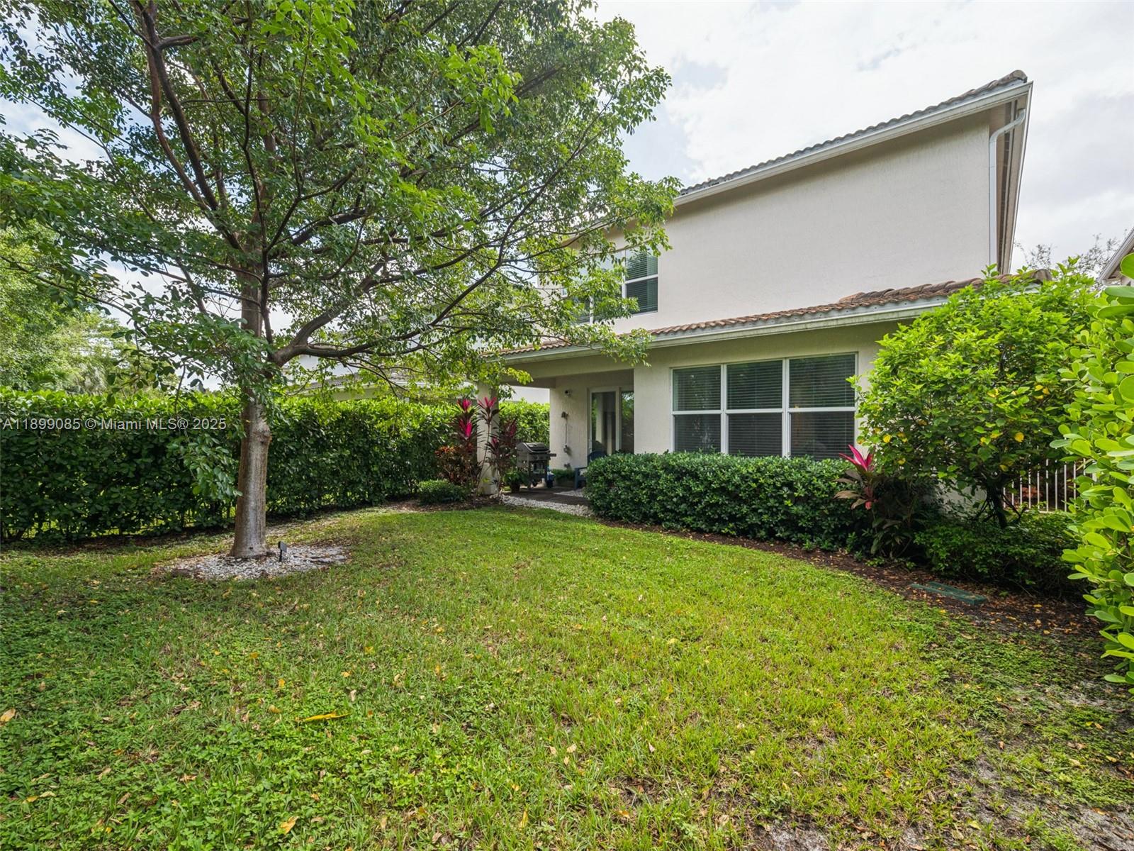 4325 Large Leaf Lane Hollywood, FL 33021 - Photo 48 of 72 a backyard of a house with plants and large tree