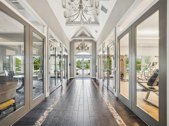 a view of swimming pool that has lawn chairs plants and lake view