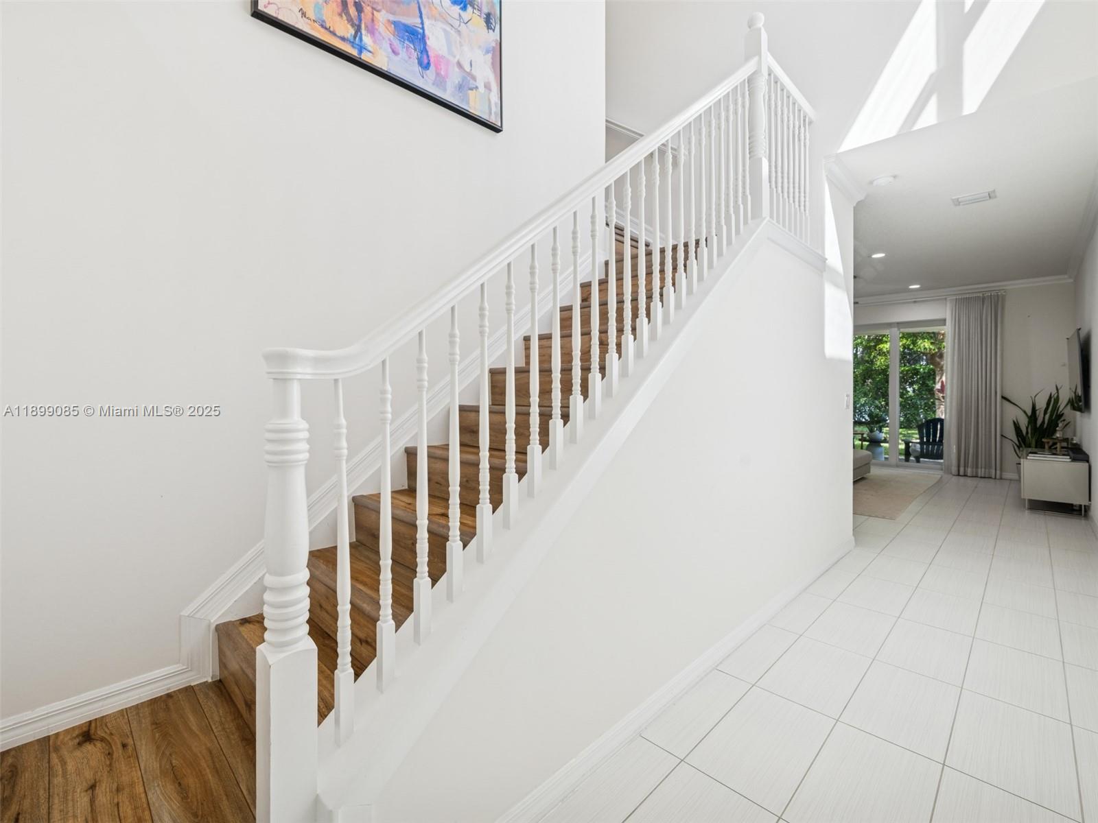 4325 Large Leaf Lane Hollywood, FL 33021 - Photo 10 of 72 a view of staircase with lots of frames on wall and a potted plant