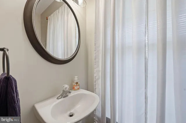 a bathroom with a sink a mirror and a toilet