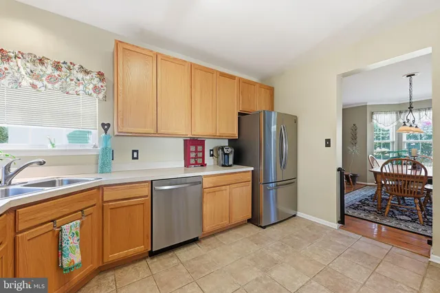 a kitchen with stainless steel appliances a refrigerator sink and cabinets