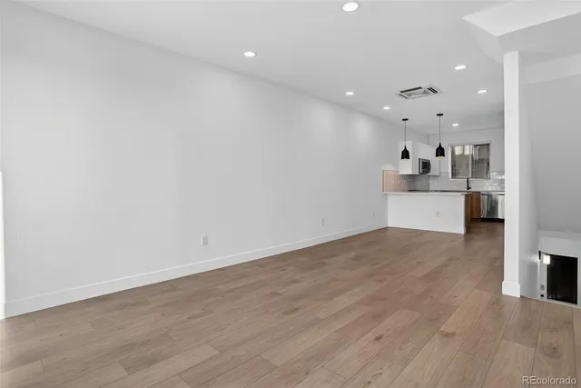 a view of a kitchen with a sink and a refrigerator