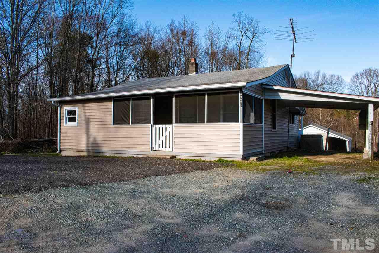 2243 Durham St Extension Burlington, NC 27217 - Photo 2 of 21 a front view of a house with a yard and garage