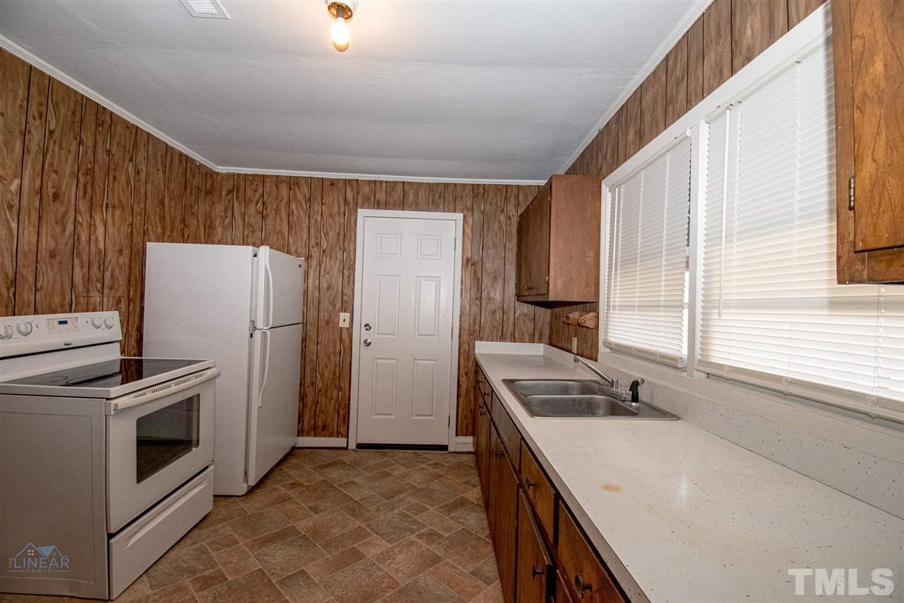 2243 Durham St Extension Burlington, NC 27217 - Photo 15 of 21 a kitchen that has a sink and a refrigerator