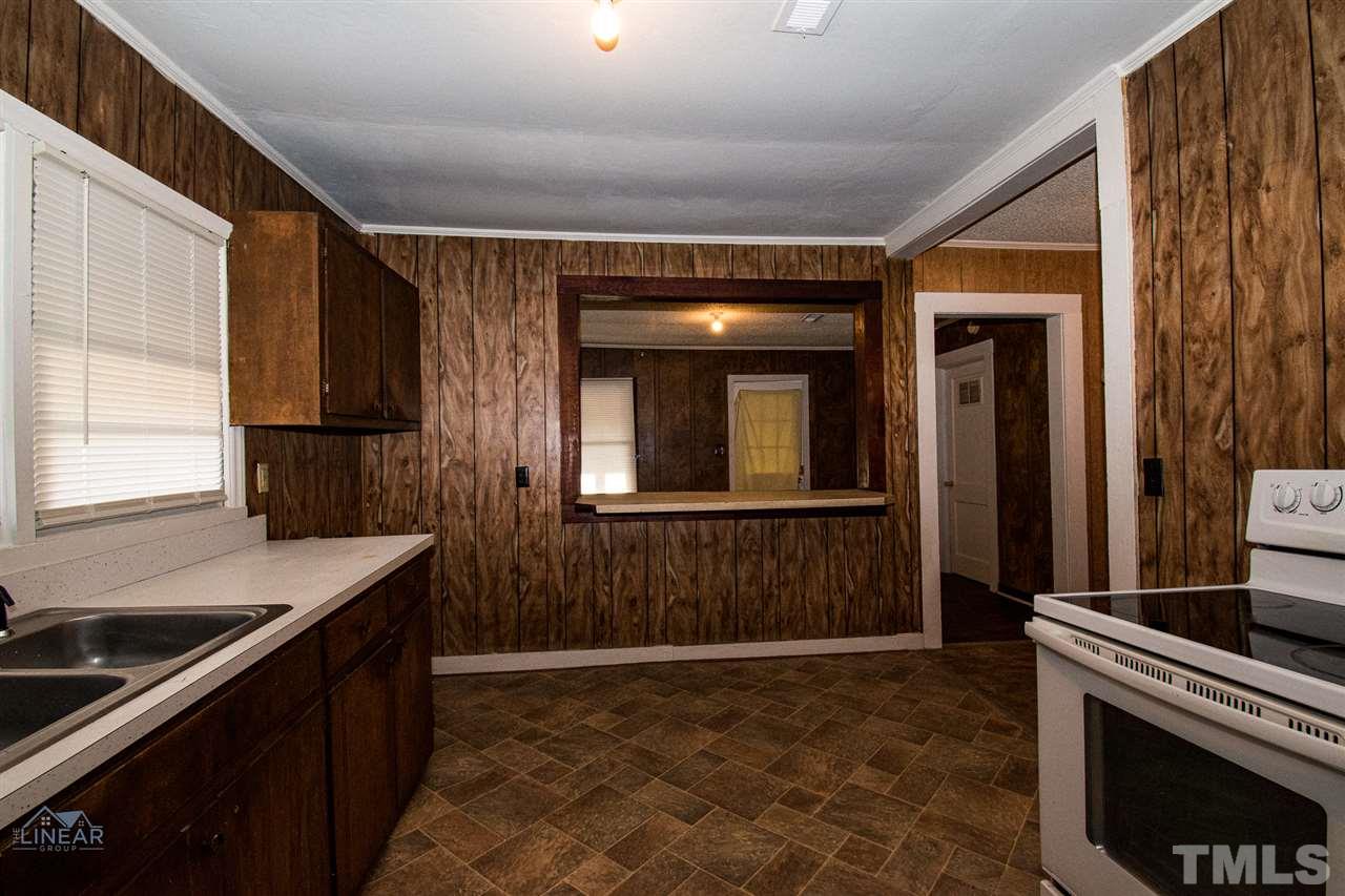 2243 Durham St Extension Burlington, NC 27217 - Photo 16 of 21 a kitchen with a sink stove and cabinets