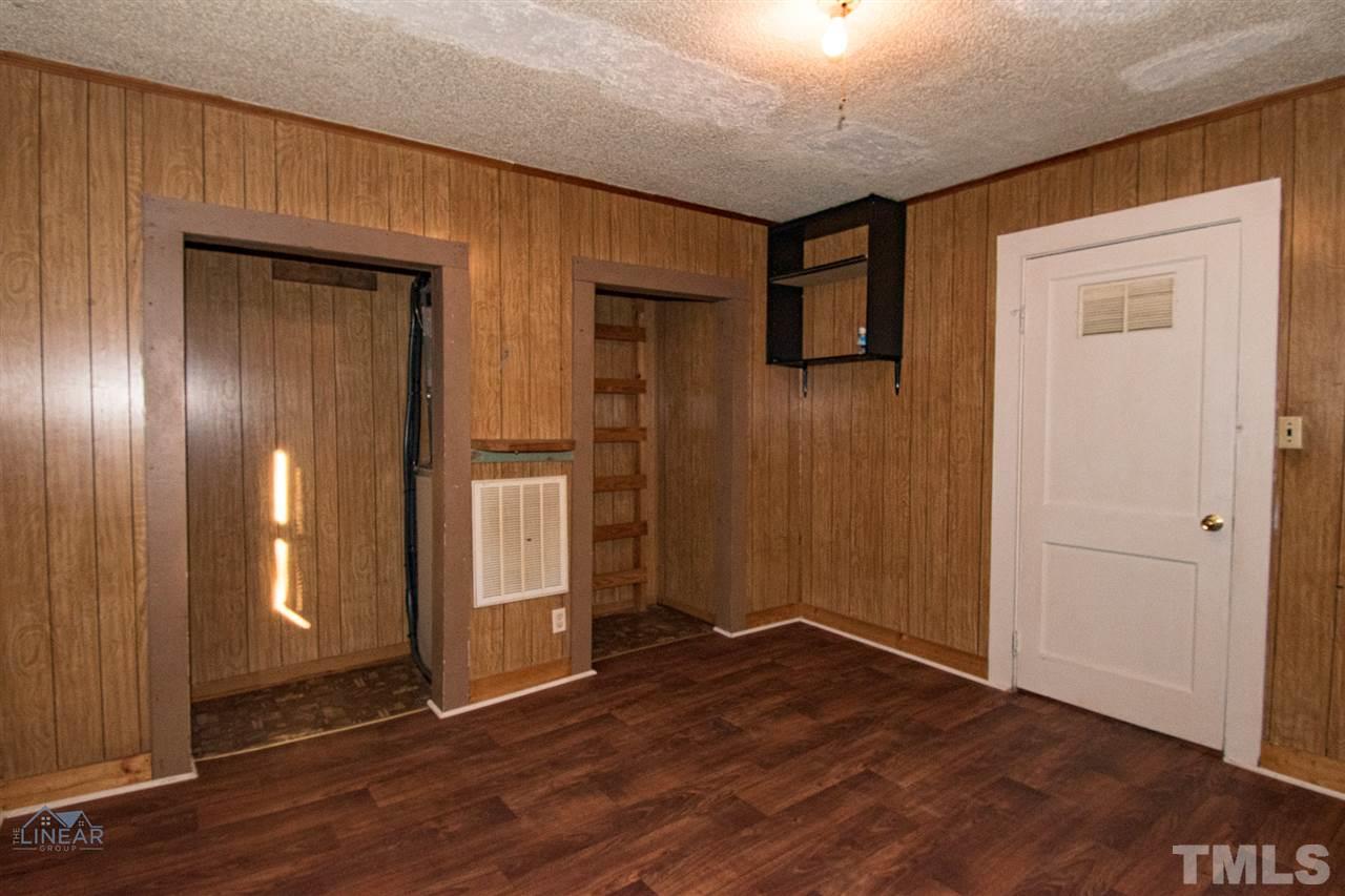 2243 Durham St Extension Burlington, NC 27217 - Photo 5 of 21 an empty room with wooden floor and windows