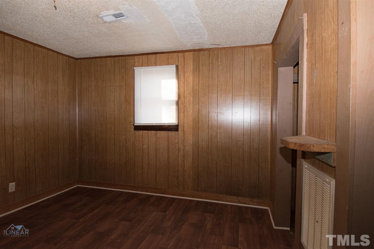 2243 Durham St Extension Burlington, NC 27217 - Photo 6 of 21 an empty room with wooden floor and windows