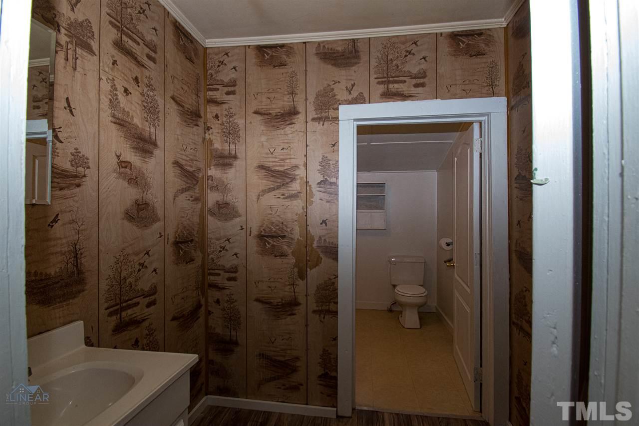 2243 Durham St Extension Burlington, NC 27217 - Photo 9 of 21 a bathroom with a shower and a toilet sink