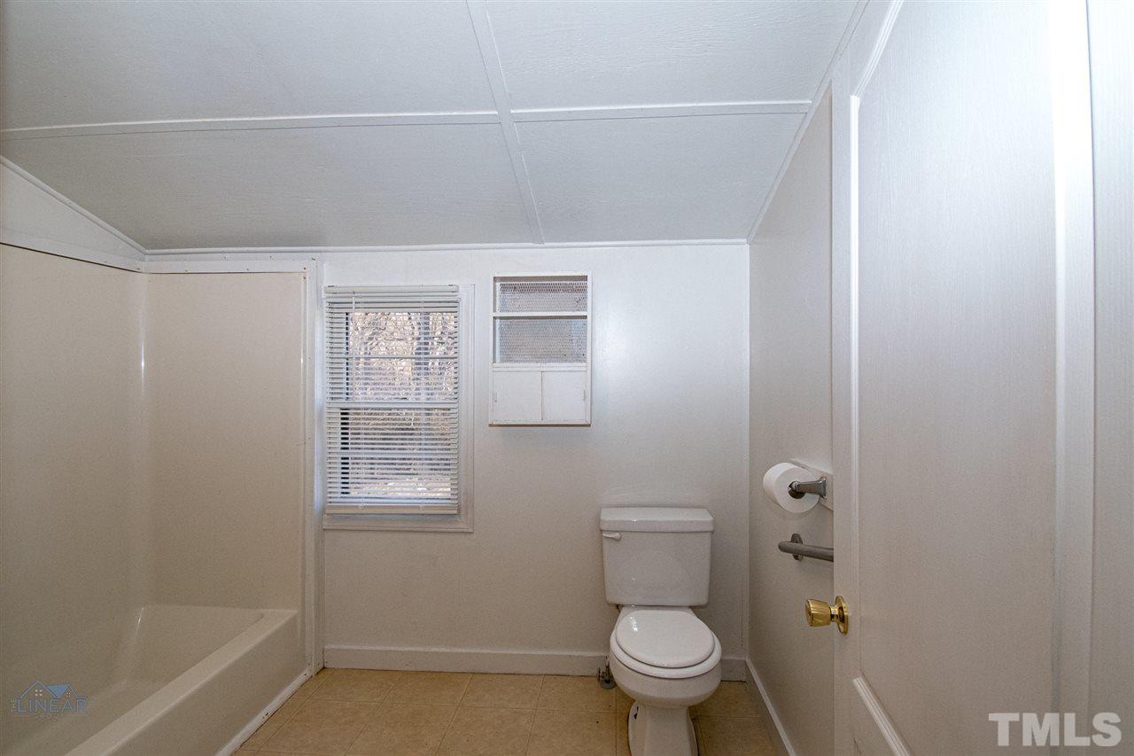 2243 Durham St Extension Burlington, NC 27217 - Photo 10 of 21 a bathroom with a toilet and a shower