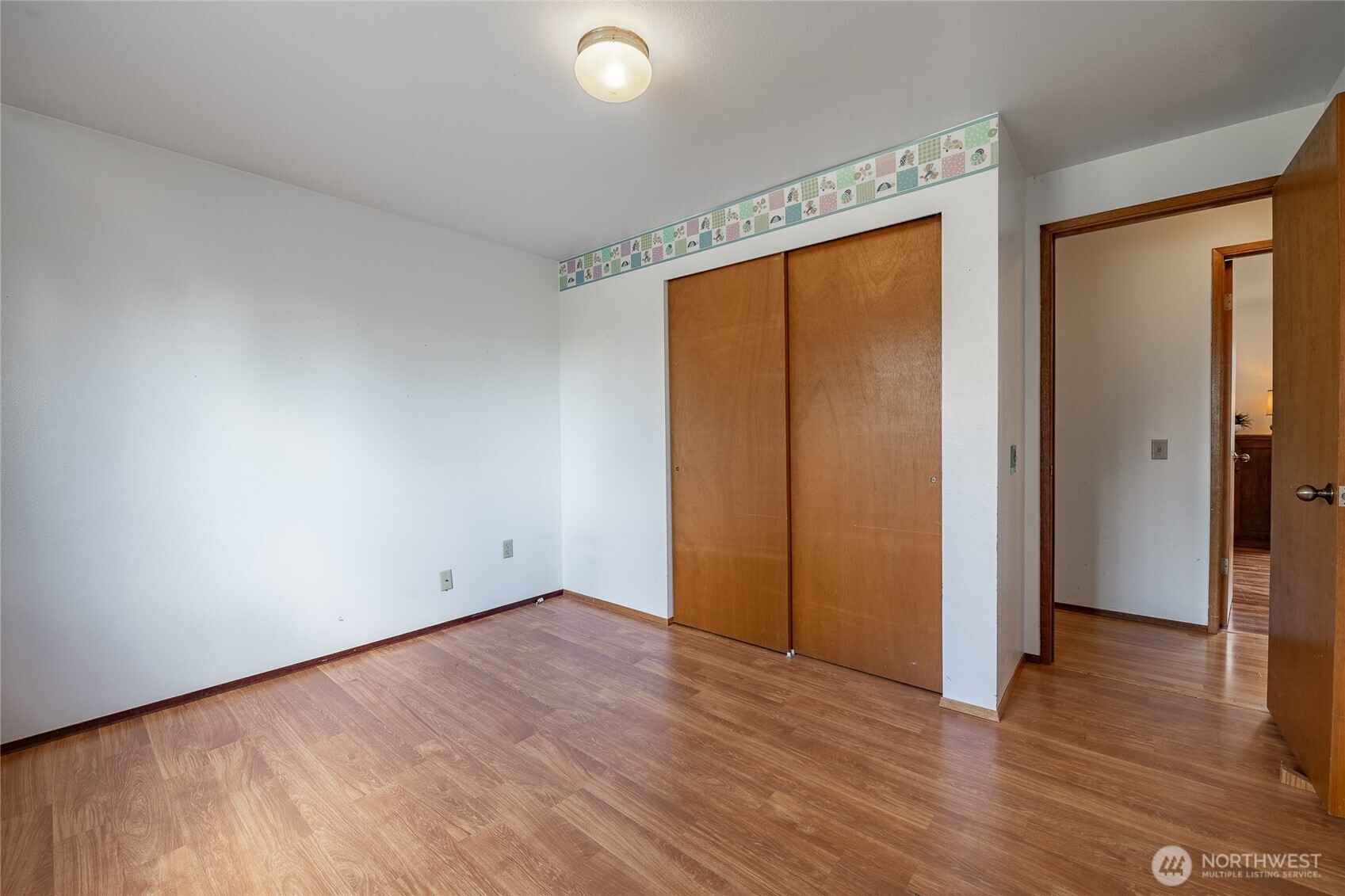 2136 Hawthorne Street Ferndale, WA 98248 - Photo 24 of 26 an empty room with wooden floor and windows