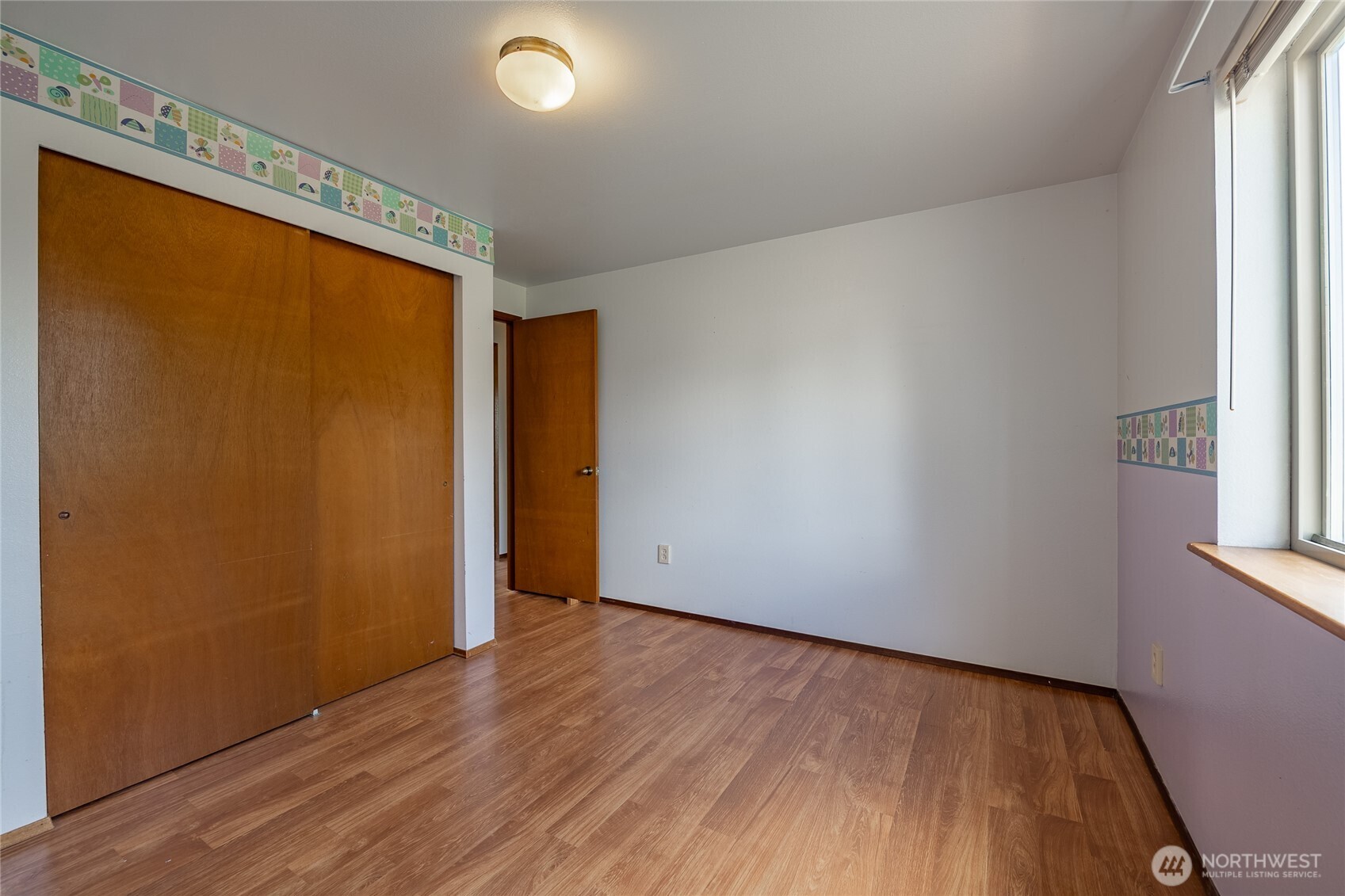 2136 Hawthorne Street Ferndale, WA 98248 - Photo 25 of 26 an empty room with wooden floor and windows