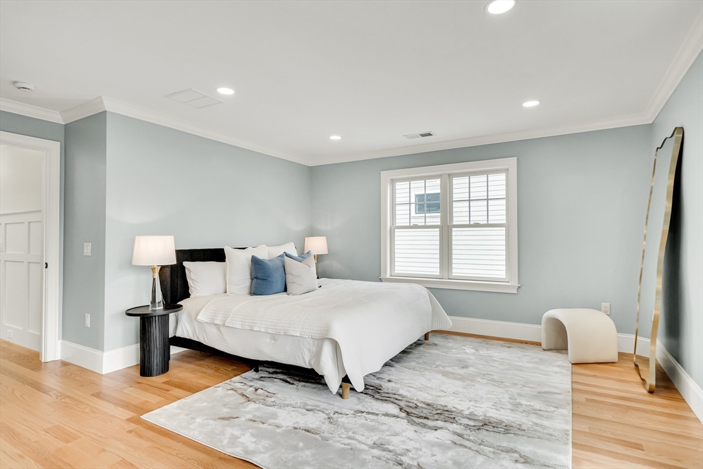 232 Lincoln Street Lexington, MA 02421 - Photo 16 of 41 a bedroom with a bed and wooden floor