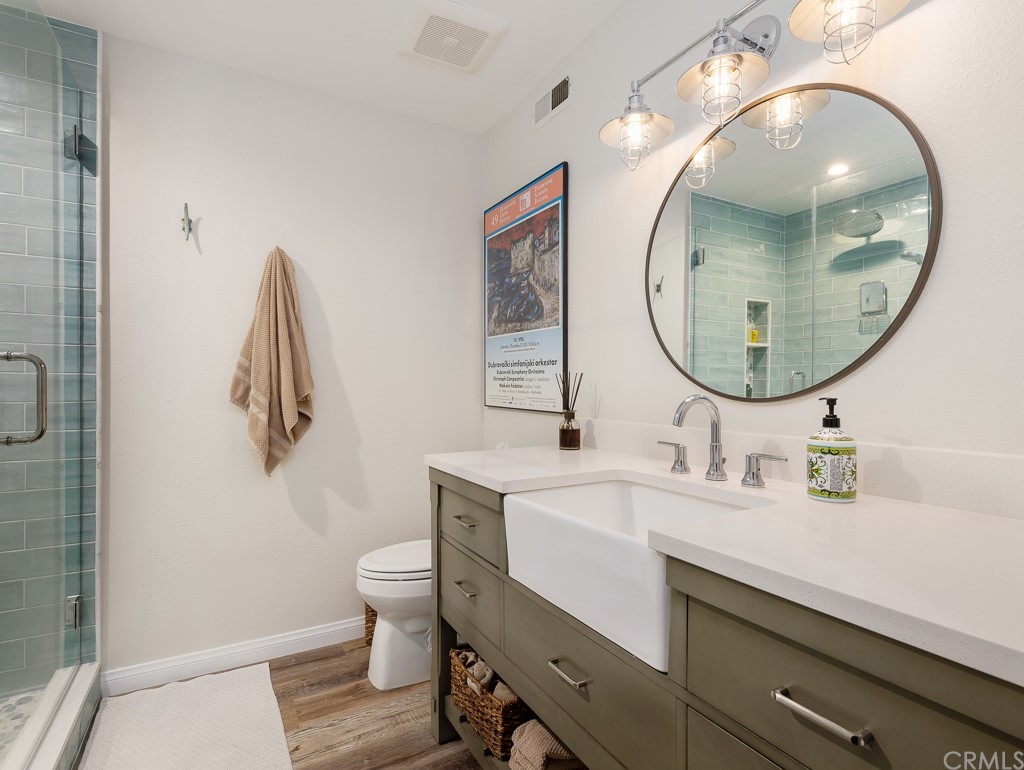 408 Richmond Street, Unit 10 El Segundo, CA 90245 - Photo 15 of 24 a bathroom with a sink mirror and toilet