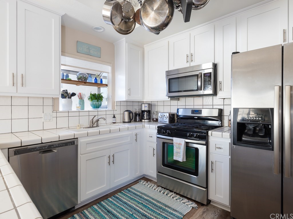 408 Richmond Street, Unit 10 El Segundo, CA 90245 - Photo 9 of 24 a kitchen with a sink stove and microwave