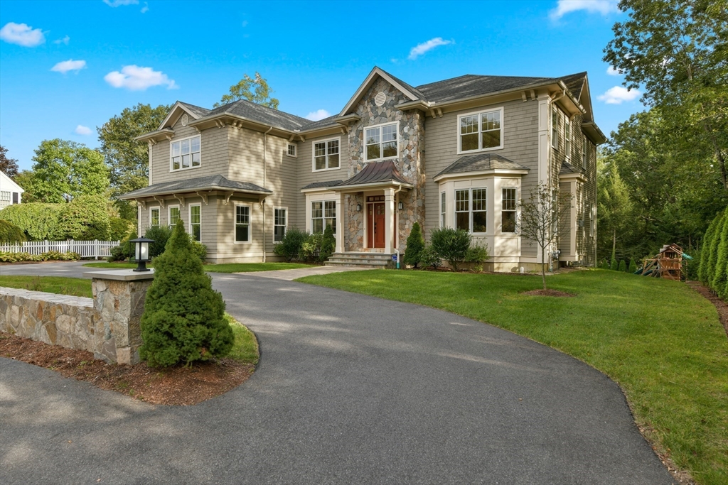 a front view of a house with a garden