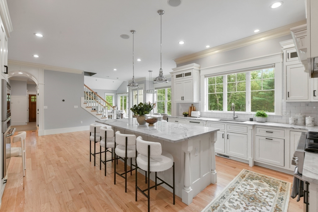 6 Norwich Road Wellesley, MA 02481 - Photo 11 of 34 a kitchen with stainless steel appliances granite countertop a table chairs sink and cabinets