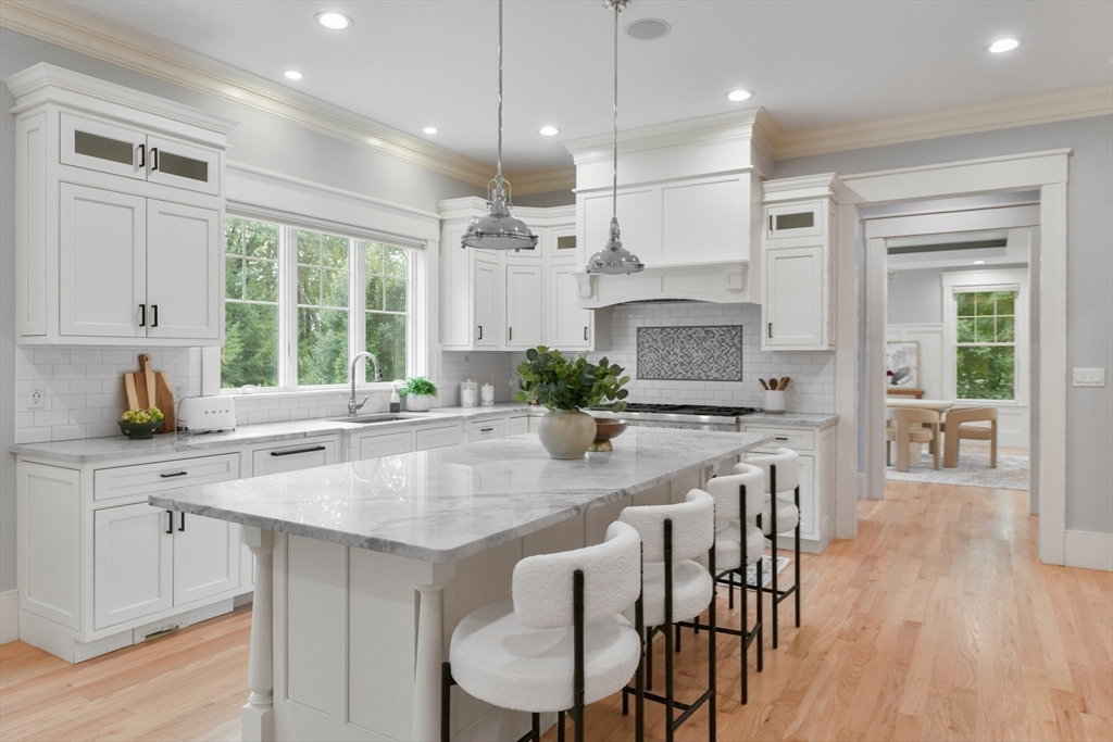 6 Norwich Road Wellesley, MA 02481 - Photo 6 of 34 a kitchen with stainless steel appliances granite countertop a stove a sink a oven a dining table and chairs