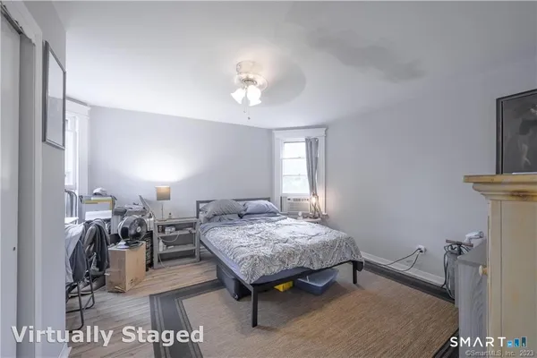 a bedroom with furniture and a mirror