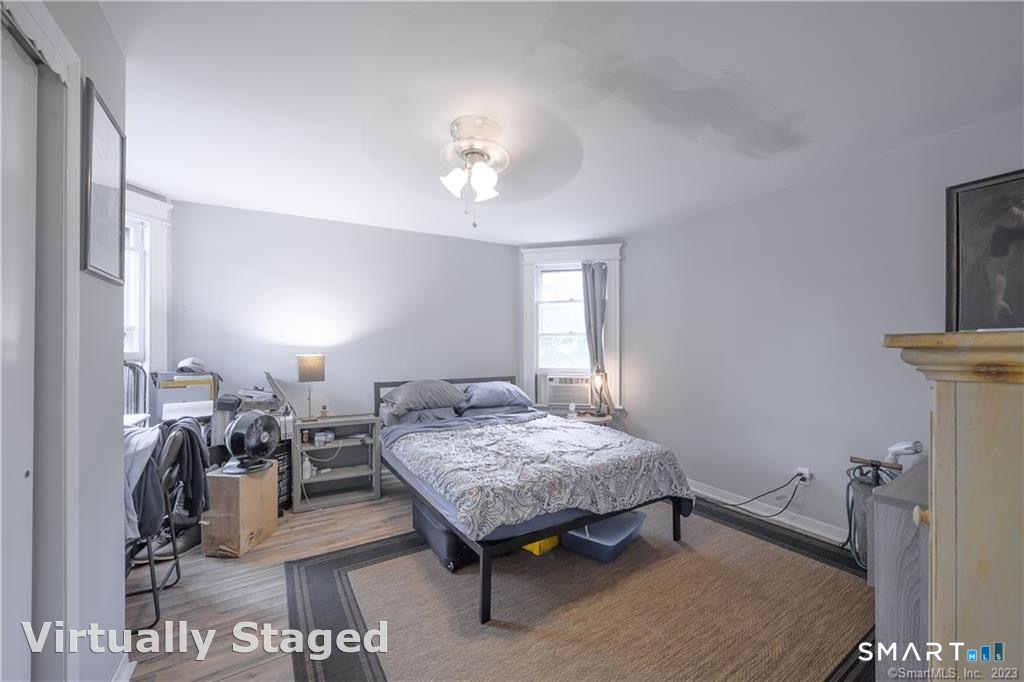 a bedroom with furniture and a mirror