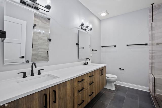 211 South Hamilton Avenue, Unit 2 Chicago, IL 60612 - Photo 13 of 22 a bathroom with a double vanity sink a toilet and a mirror