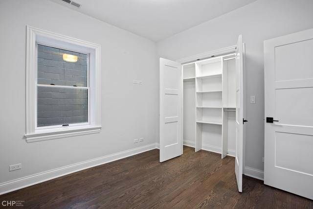 211 South Hamilton Avenue, Unit 2 Chicago, IL 60612 - Photo 16 of 22 a view of an empty room with a closet and wooden floor