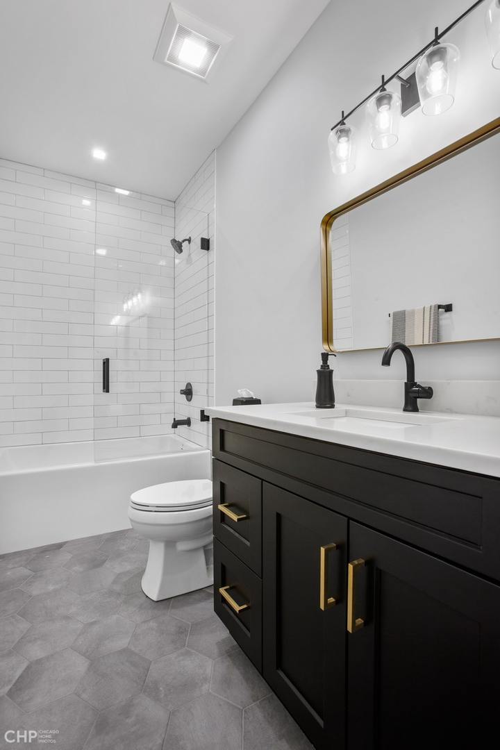 211 South Hamilton Avenue, Unit 2 Chicago, IL 60612 - Photo 18 of 22 a bathroom with a double vanity sink toilet and shower