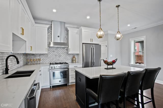 211 South Hamilton Avenue, Unit 2 Chicago, IL 60612 - Photo 7 of 22 a kitchen with a dining table and chairs
