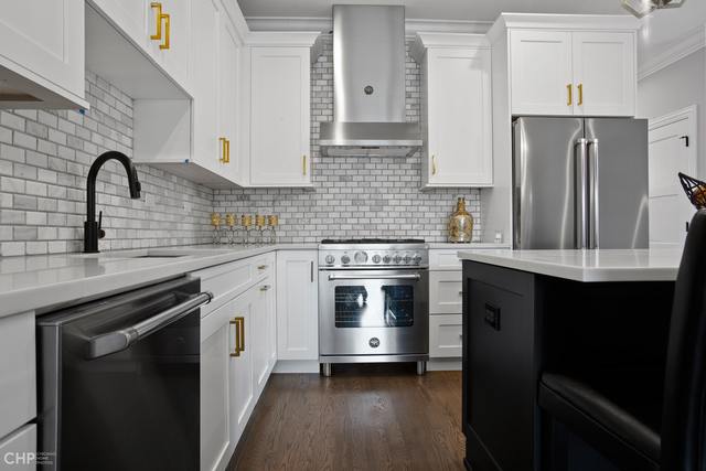 211 South Hamilton Avenue, Unit 2 Chicago, IL 60612 - Photo 8 of 22 a kitchen with stainless steel appliances a stove sink and refrigerator