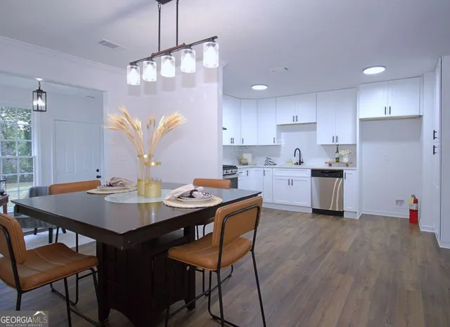 a kitchen with a table chairs stove and microwave