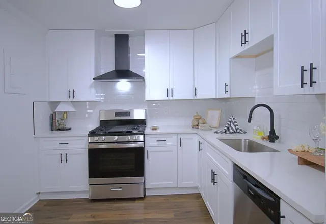 a kitchen with cabinets appliances and a sink