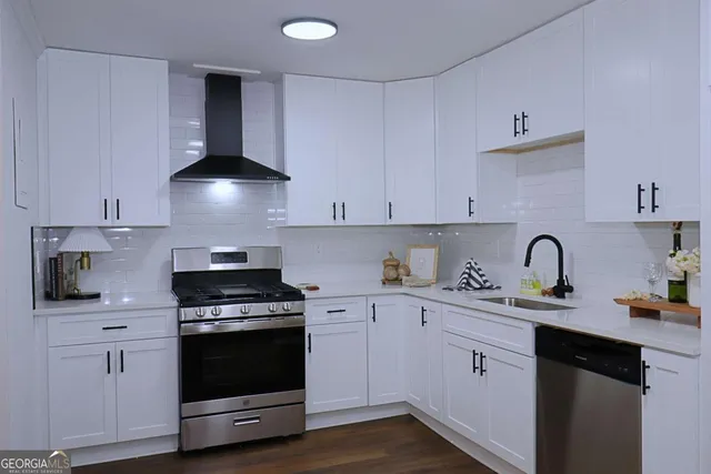 a kitchen with stainless steel appliances a sink stove and cabinets