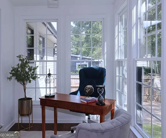 a view of a workspace with furniture and a potted plant