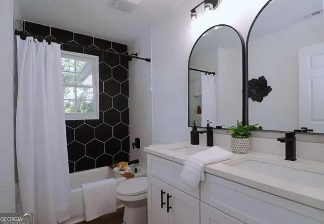 a bathroom with a sink a toilet and a mirror