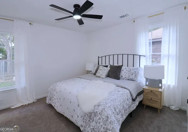 a bed room with a bed and a window