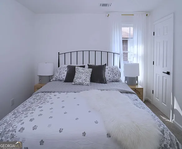 a bedroom with a bed and closet