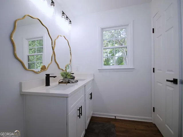a bathroom with a sink toilet and a mirror