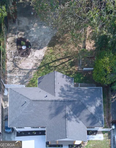 an aerial view of a house with a yard